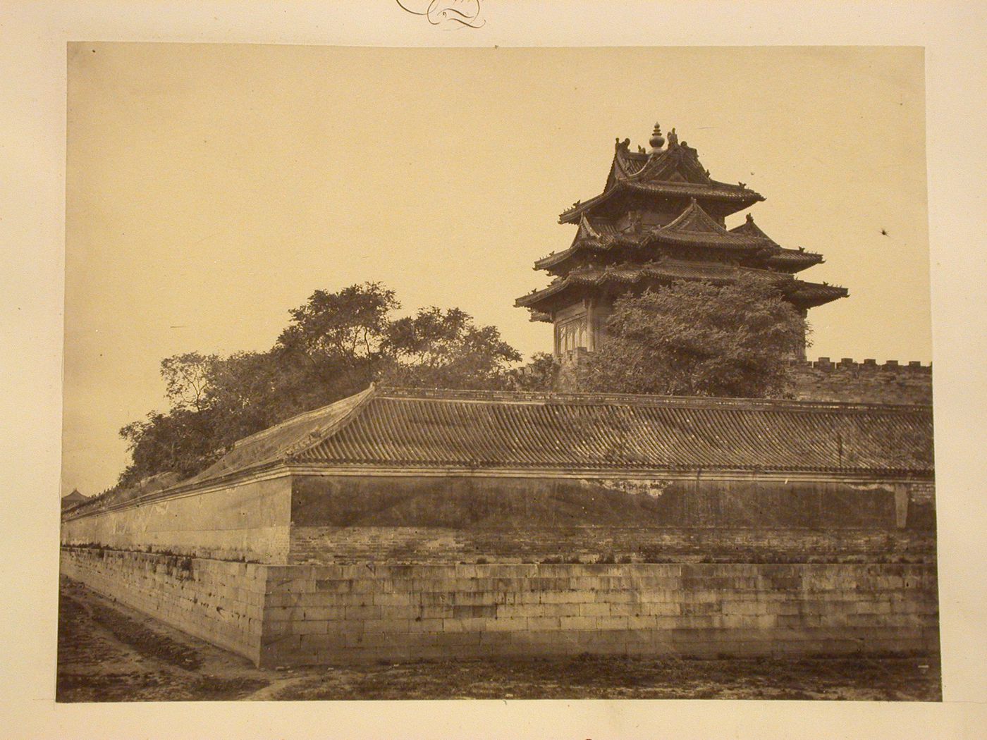 View of a corner tower of the Forbidden City from outside de wall, Peking (now Beijing), China