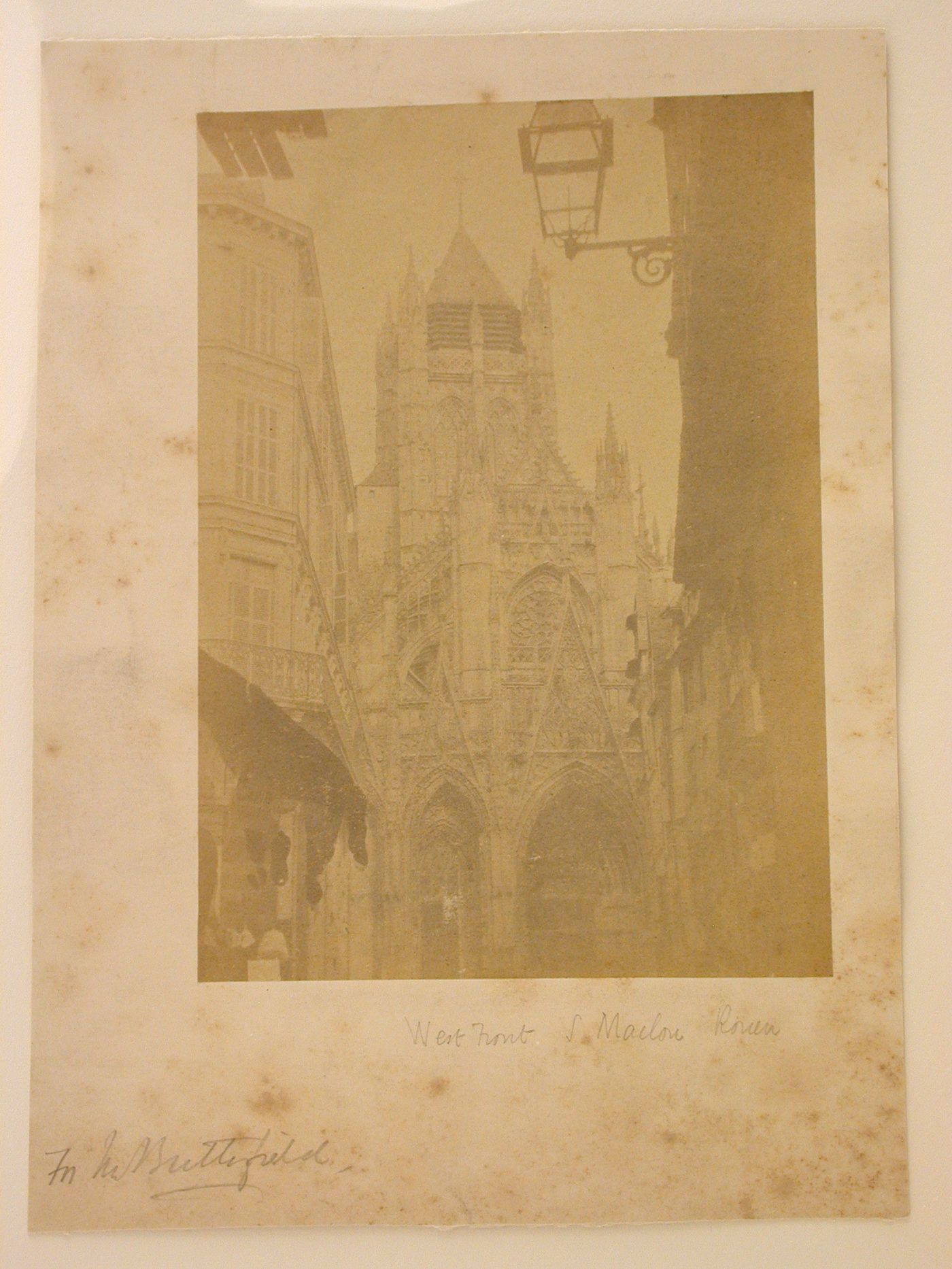 Partial view of the west façade of the Church of S. Maclou taken through a street, Rouen, France