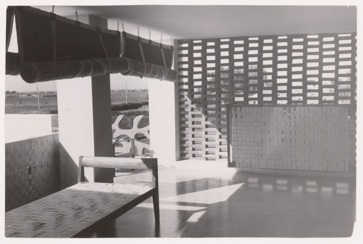 View of a modernized traditional bed and straw blinds in a loggia, Chandigarh, India
