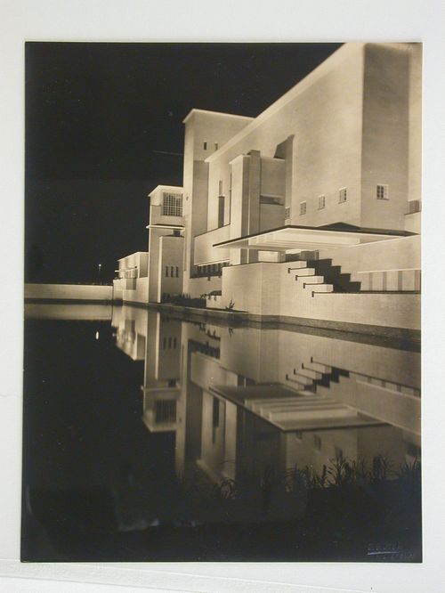 Town Hall partial view of pool and building lit and reflected in water at night, Hilversum, Netherlands