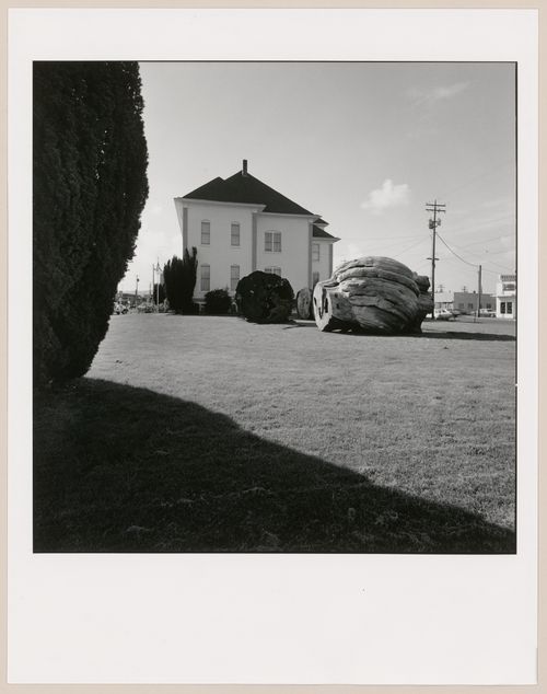 Side view of the Tillamook County Pioneer Museum (formerly the Tillamook County Courthouse) with sections of  cut-down cedar tree in yard, 2106 2nd Street, Tillamook, Oregon, United States