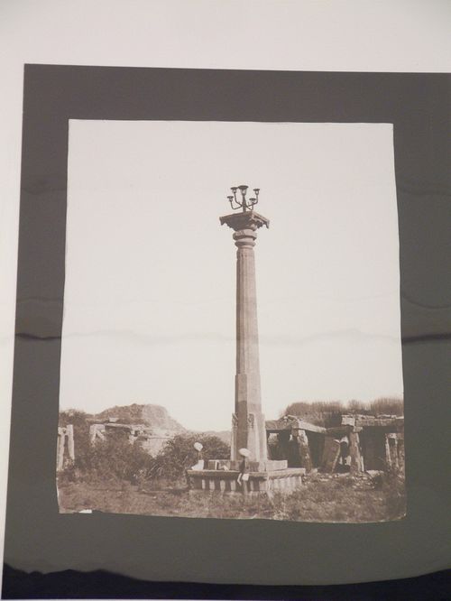 View of the Deepastambha [lamp post] with mandapas of the Vithala Temple Complex in the background, Vijayanagara, Hampi, India