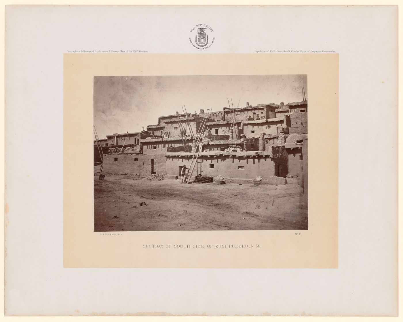 View of section of south side of Zuni, with an  A:shiwi person on ladder in the foreground, New Mexico, United States