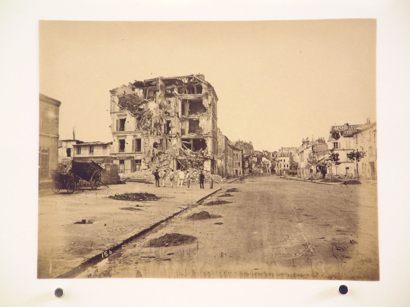 View of a street showing men inspecting the damage after the Paris Commune uprising of 1871, Paris, France