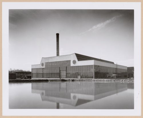 General view of the principal [?] façade of the Roll and Heavy Machine Shop from across a river [?], Ohio Steel Foundry, Lima, Ohio