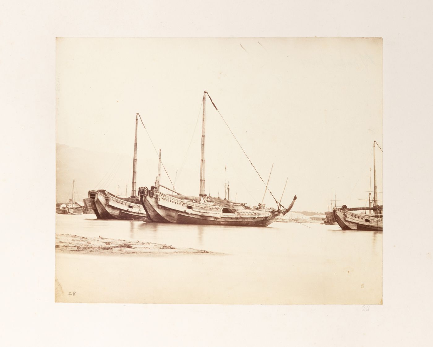View of junks and a harbour showing buildings in the background, Hyogo (now part of Kobe), Japan