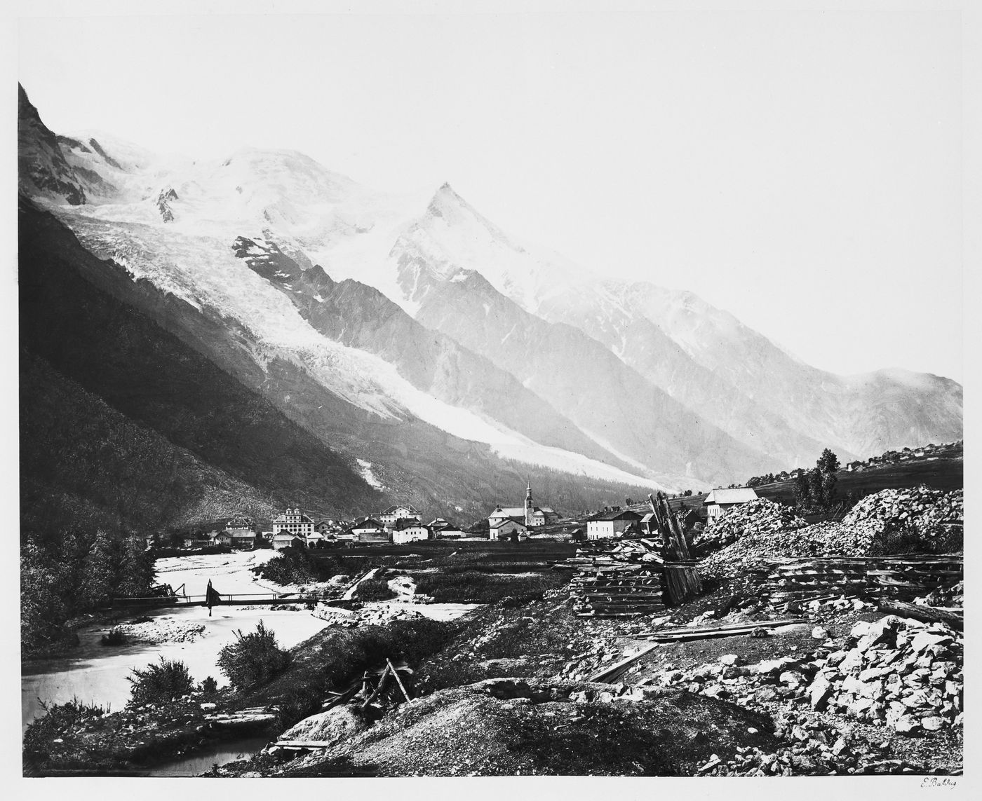 View of a village in a valley with mountains and glacier in the background, France
