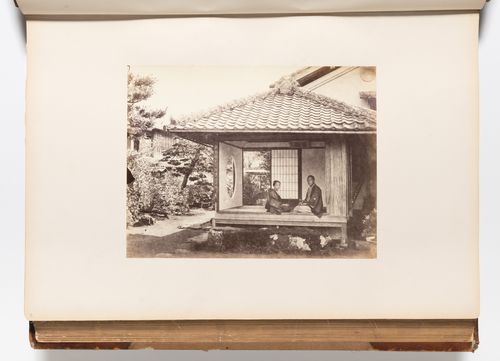 View of a woman and a man sitting in the entrance to a teahouse with a garden in the background, probably Edo (now Tokyo), Japan
