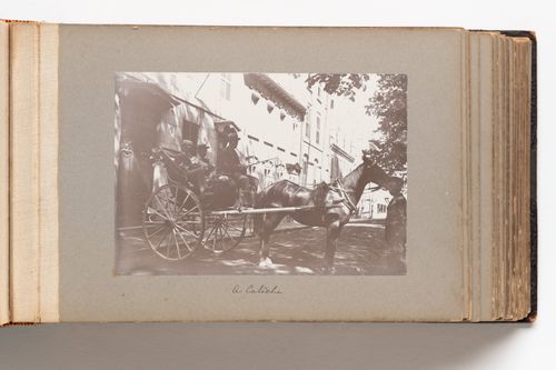 View of a horse-drawn carriage, with passengers and driver, on a street in Quebec City, Quebec, Canada