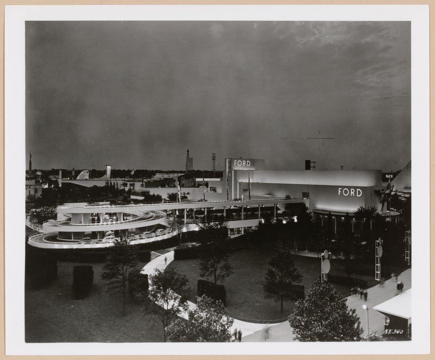View of the Ford Motor Company pavilion at night showing a ramp and automobiles, 1939-1940 New York World's Fair, New York City, New York