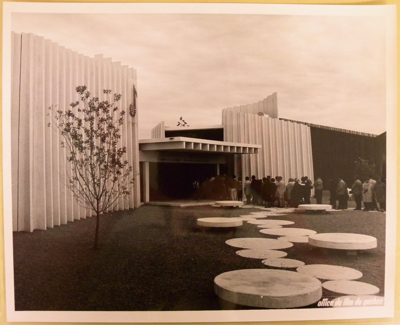 View of visitors standing in line at the Pavilion of the Jeunesses Musicales of Canada, Expo 67, Montréal, Québec