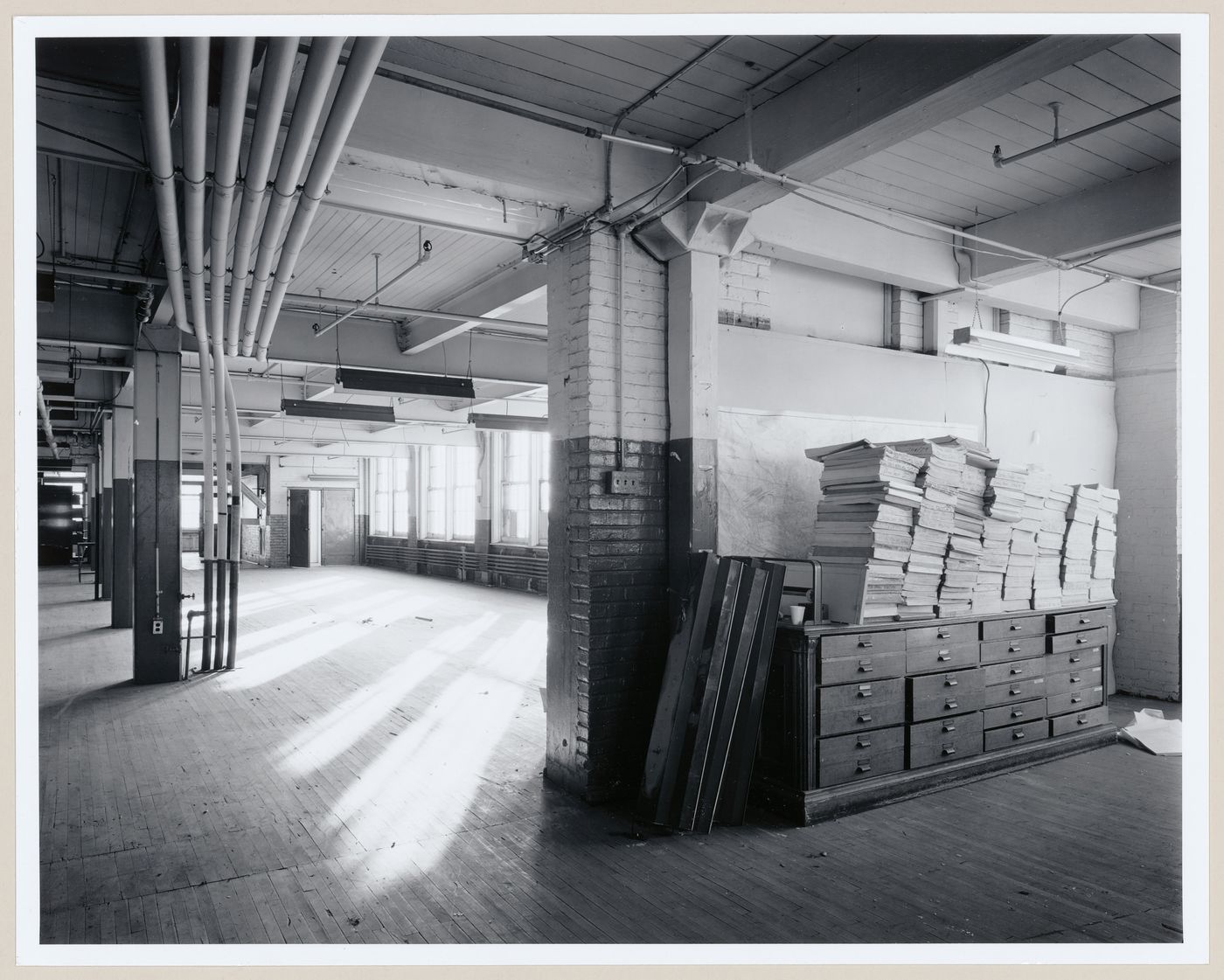 Interior view of an office area on the third floor of the administration building of the Belding Corticelli Spinning Mill showing pneumatic dispatch tubes, Montréal, Québec