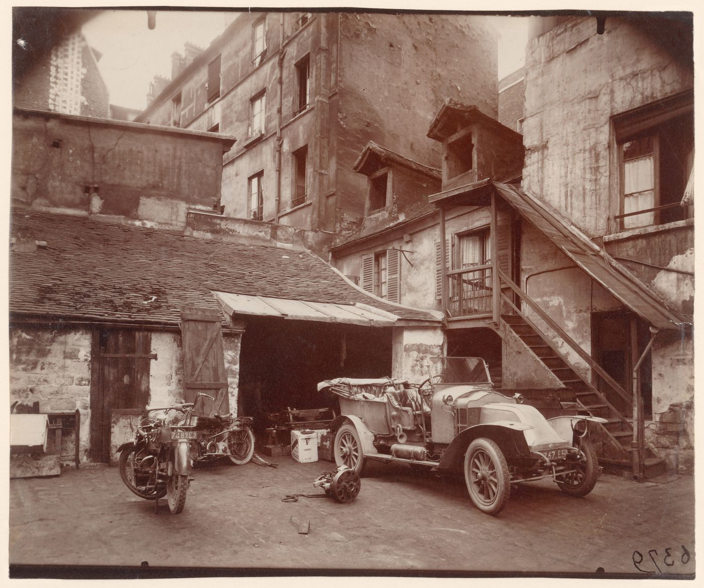 Car, motorcycle, and garage, Cour, Rue de Valence, Paris, France