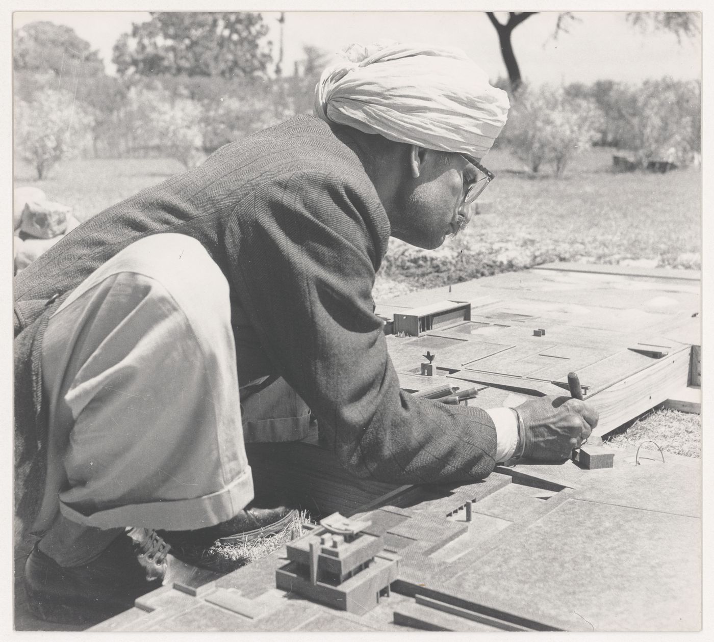 Portrait of the model maker, Dhani Ram, at work on the model for Capitol Complex, Sector 1, Chandigarh, India