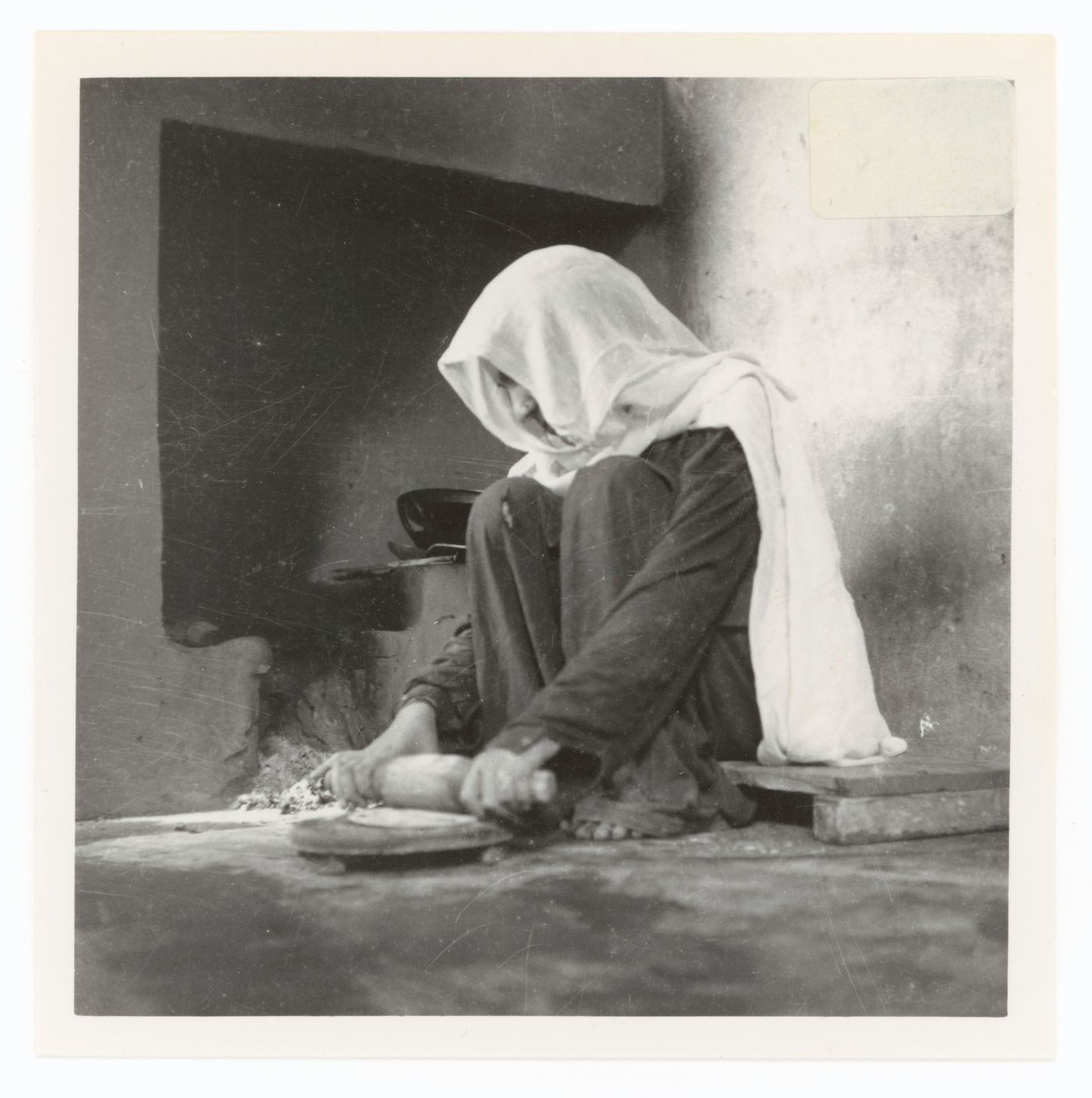 View of an unidentified woman cooking, possibly in Chandigarh, India