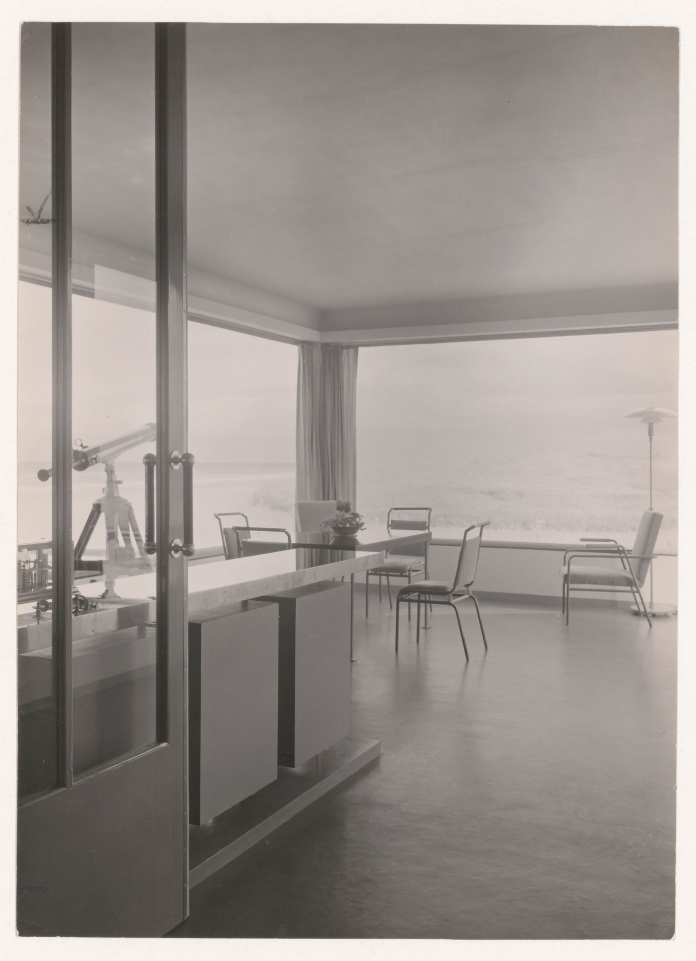 Interior view of the lounge of Villa Allegonda showing a table, chairs and built-in furniture designed by J.J.P. Oud, Katwijk aan Zee, Netherlands