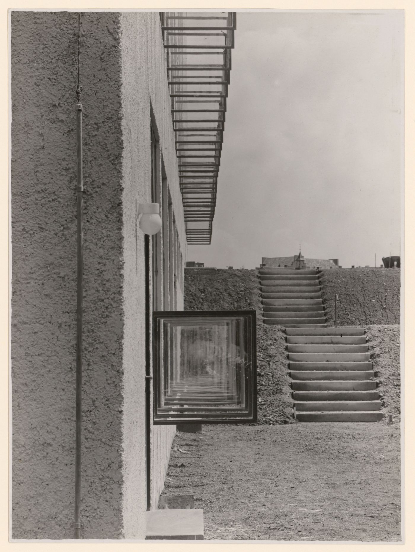View of unidentified building exterior view along façade and opened windows and outdoor steps, Aachen [?], Germany