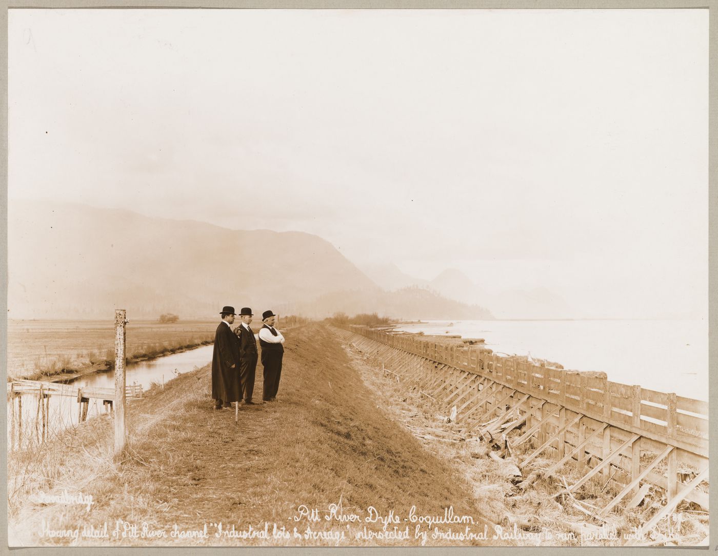 View of the Pitt River dike showing the channel and industrial acreage, Coquitlam (now Port Coquitlam), British Columbia