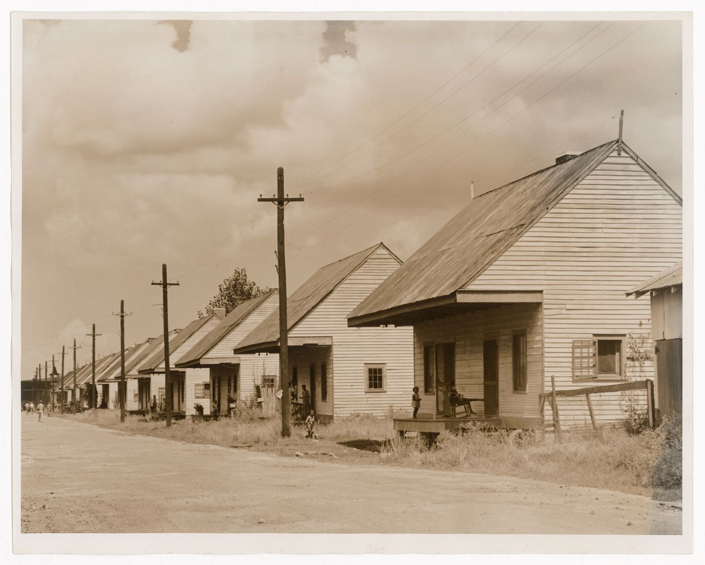 Street view of row of wooden houses with overhangs and porches, near the former Destrehan Plantation, Louisiana, United States