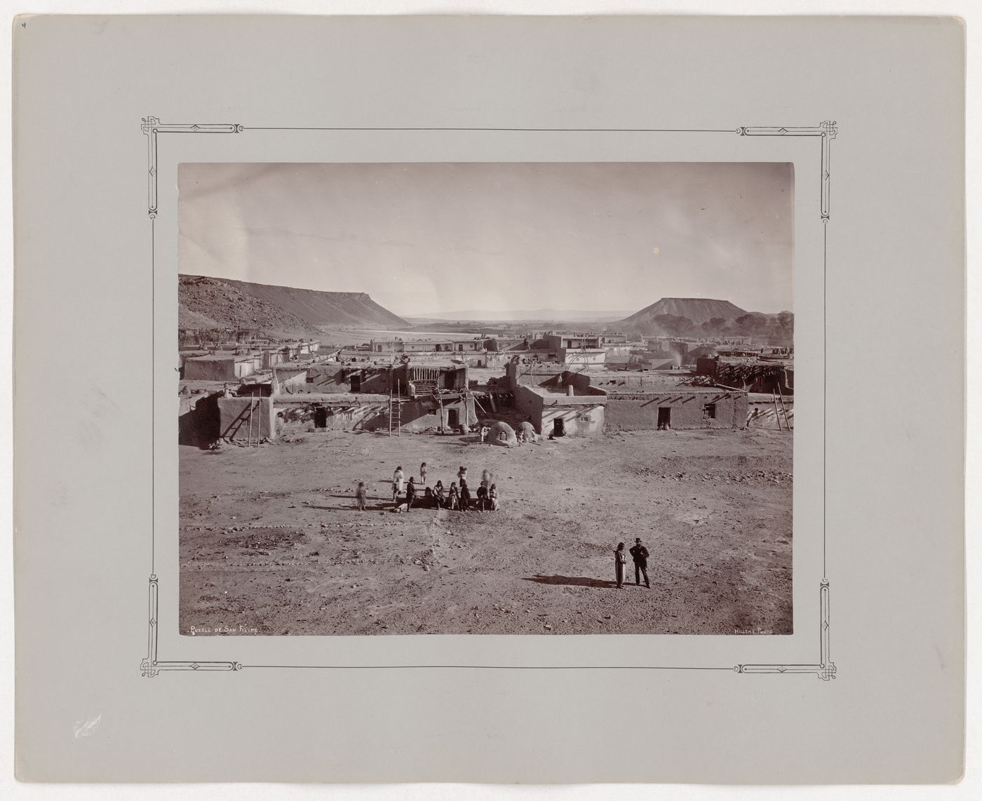 View of houses around main plaza of Katishtya (San Felipe Pueblo) showing mesas and the Rio Grande river visible in the distance, New Mexico, United States