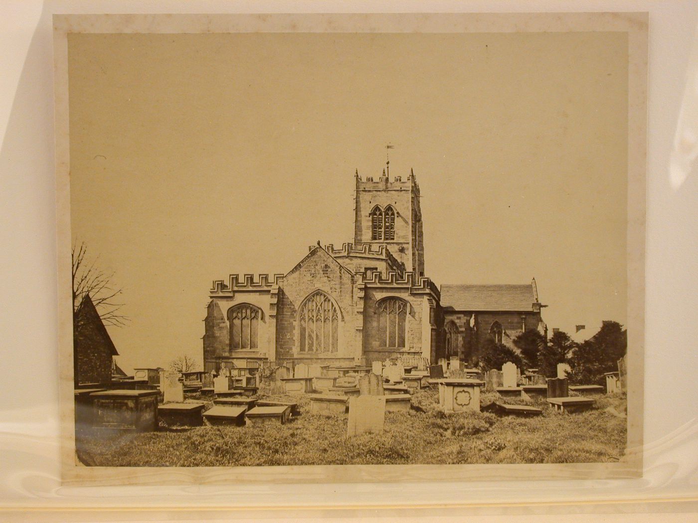 Partial view of a church showing its apse and cemetery in the foreground, England