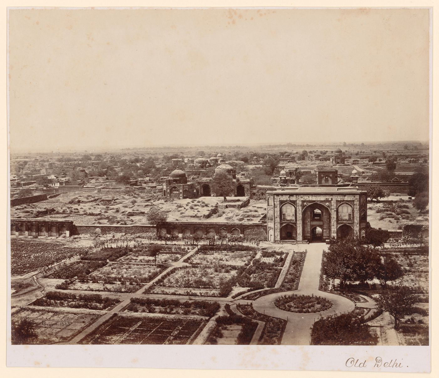 View showing a gateway, the remains of fortifications, and formal gardens in the foreground, Delhi, India
