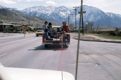 Photograph of people in back of truck spray painting for Red Line