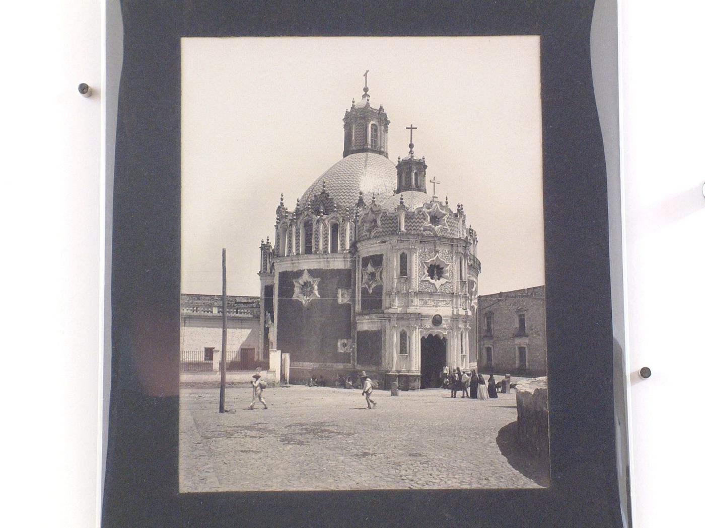 View of the Capilla del Pocito showing a square in the foreground with people throughout, Guadalupe Hidalgo (now Gustavo A. Madero, in Mexico City), Mexico