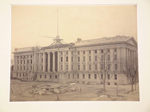 Treasury Building under contruction: Workmen and crane on scaffolding in center roof section, Washington, District of Columbia