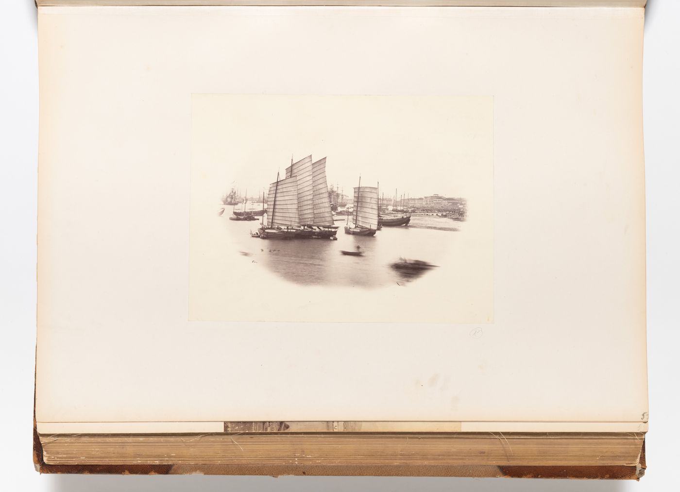 Vignette of junks and other sailing ships on the Wusong Jiang (also known as Suzhou River) showing buildings in the background, Shanghai, China