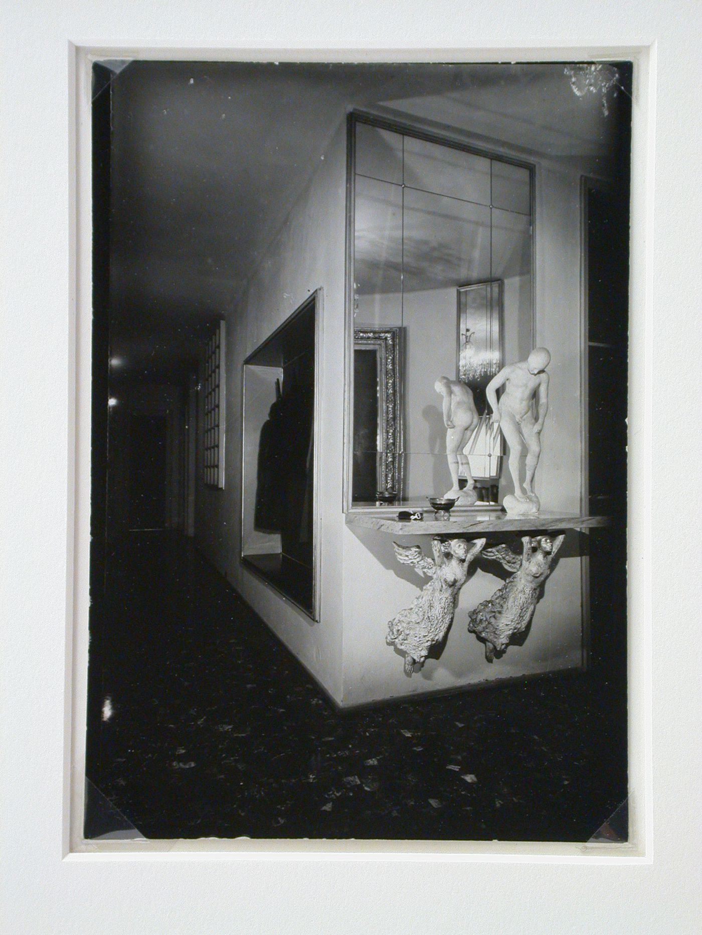 Interior view of Casa Ada and Cesare Minola showing the entrance hall with a mirror and a male nude sculpture standing on a shelf supported by two caryatids, Turin, Italy