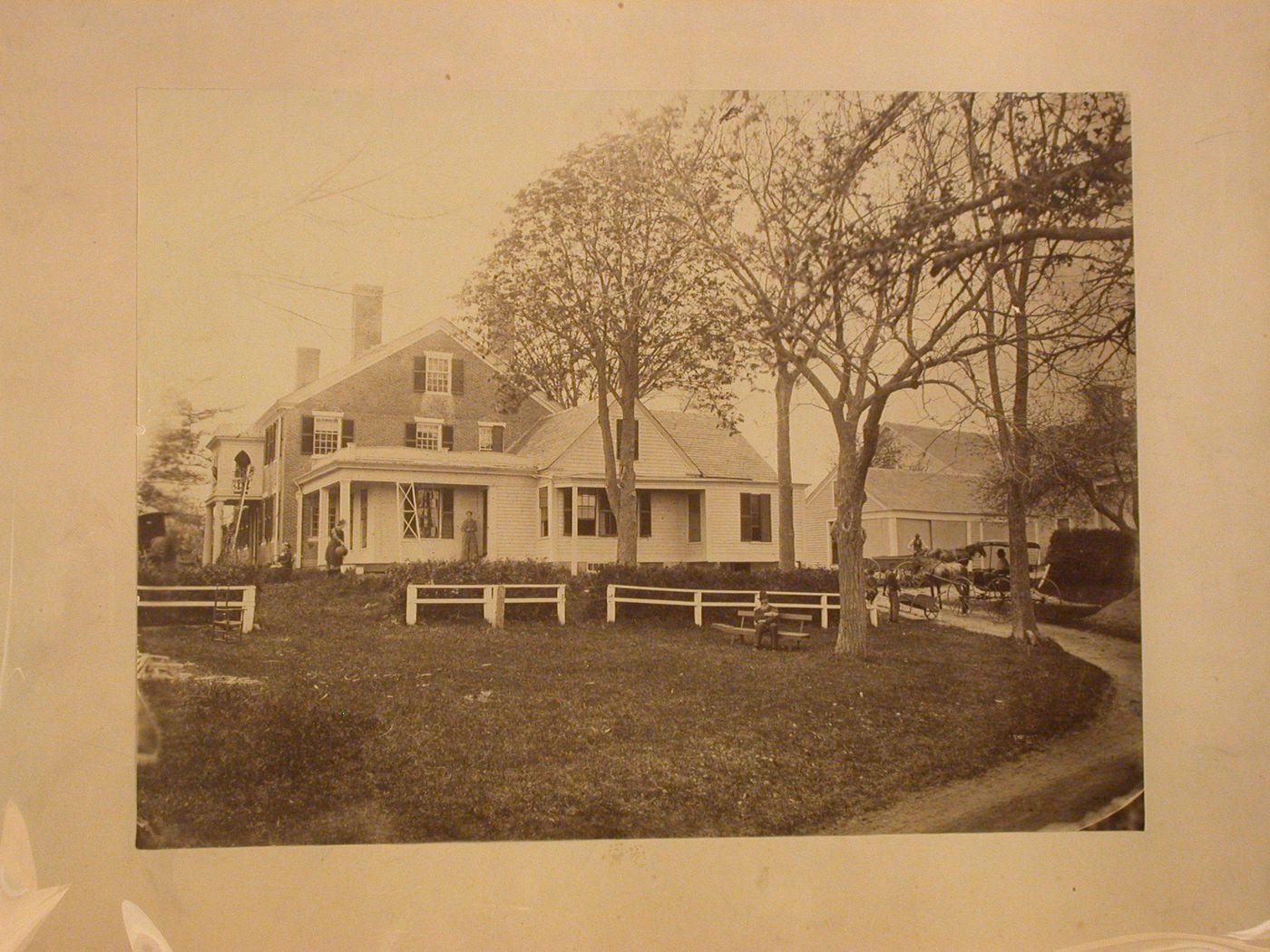 Brick house and barns, with figures in yard and driveway, Boston, Massachusetts