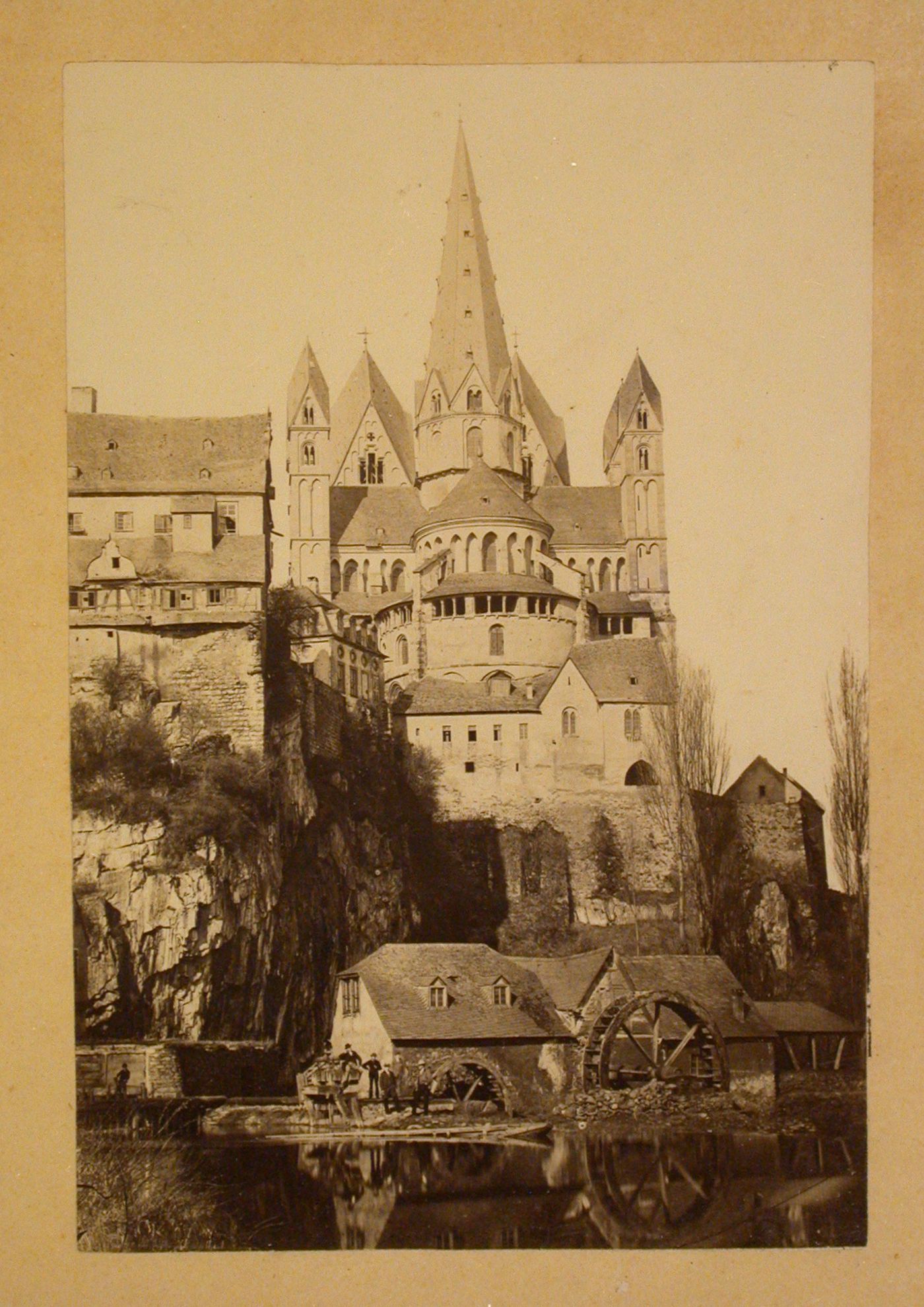 View of the rear of the Limburger Dom taken from across a river showing waterwheels and surrounding buildings, Limburg an der Lahn, Germany