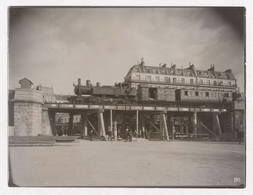 Construction of the Paris Metro, exterior view with train on raised bridge with men standing under the bridge, Paris, France