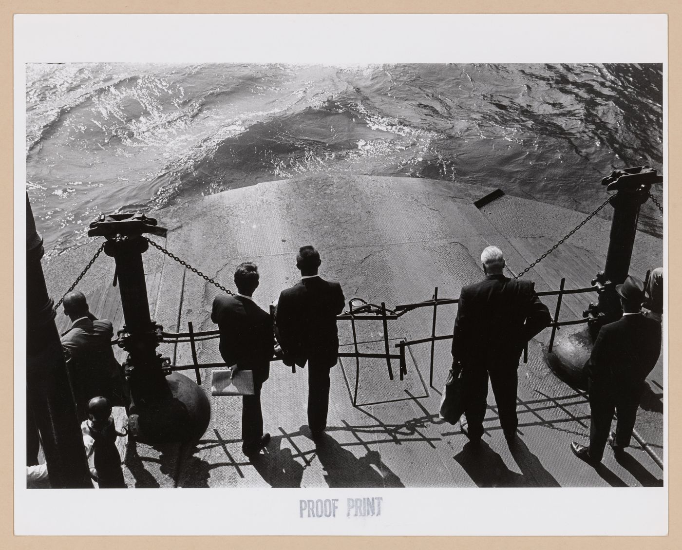 View of men standing on the deck of the Hoboken Ferry looking at the water