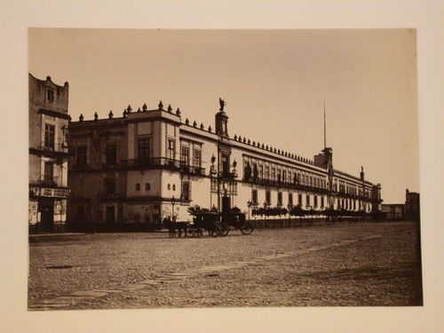 View of the principal façade of the Palacio Nacional from the Plaza de la Constitución with horse-drawn carriages in the foreground, Mexico City, Mexico