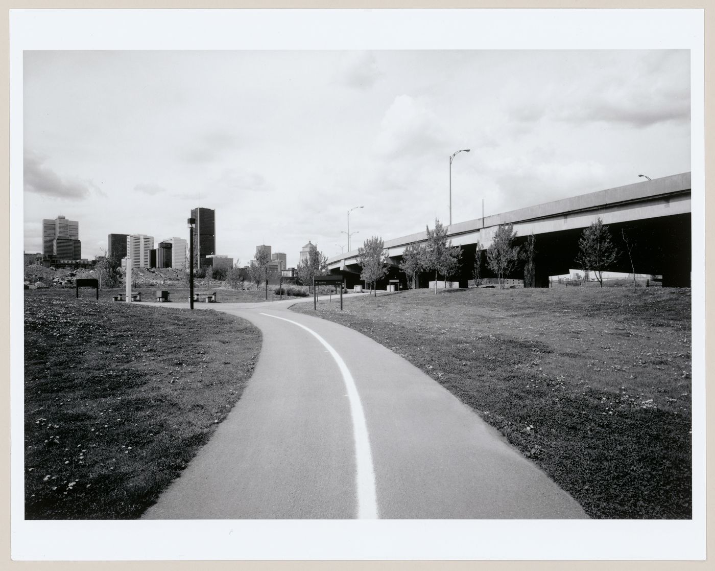 View of the bicycle path at Wellington Basin with downtown Montréal in the background and the Bonaventure Expressway on the right, Québec