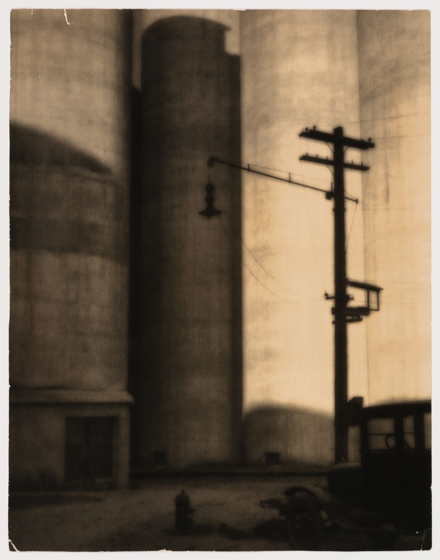 View of a grain elevator with a utility pole and a man in the foreground, Vancouver, British Columbia