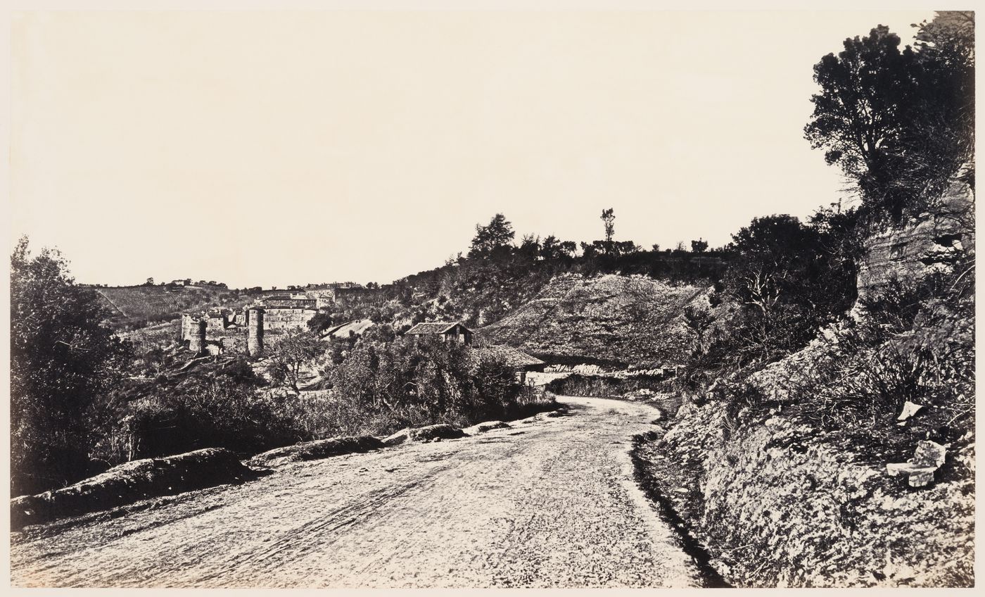 View of a road with a town in the distance in the Roman Campagna, Italy
