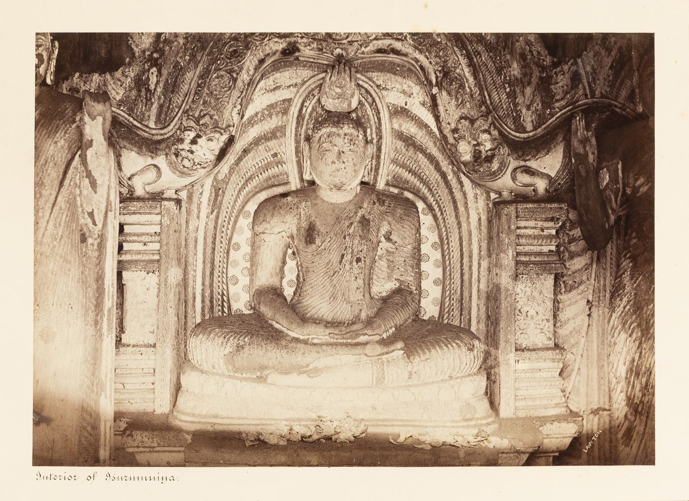Interior view of Isurumuniya Temple showing a statue of Buddha, Anuradhapura, Ceylon (now Sri Lanka)
