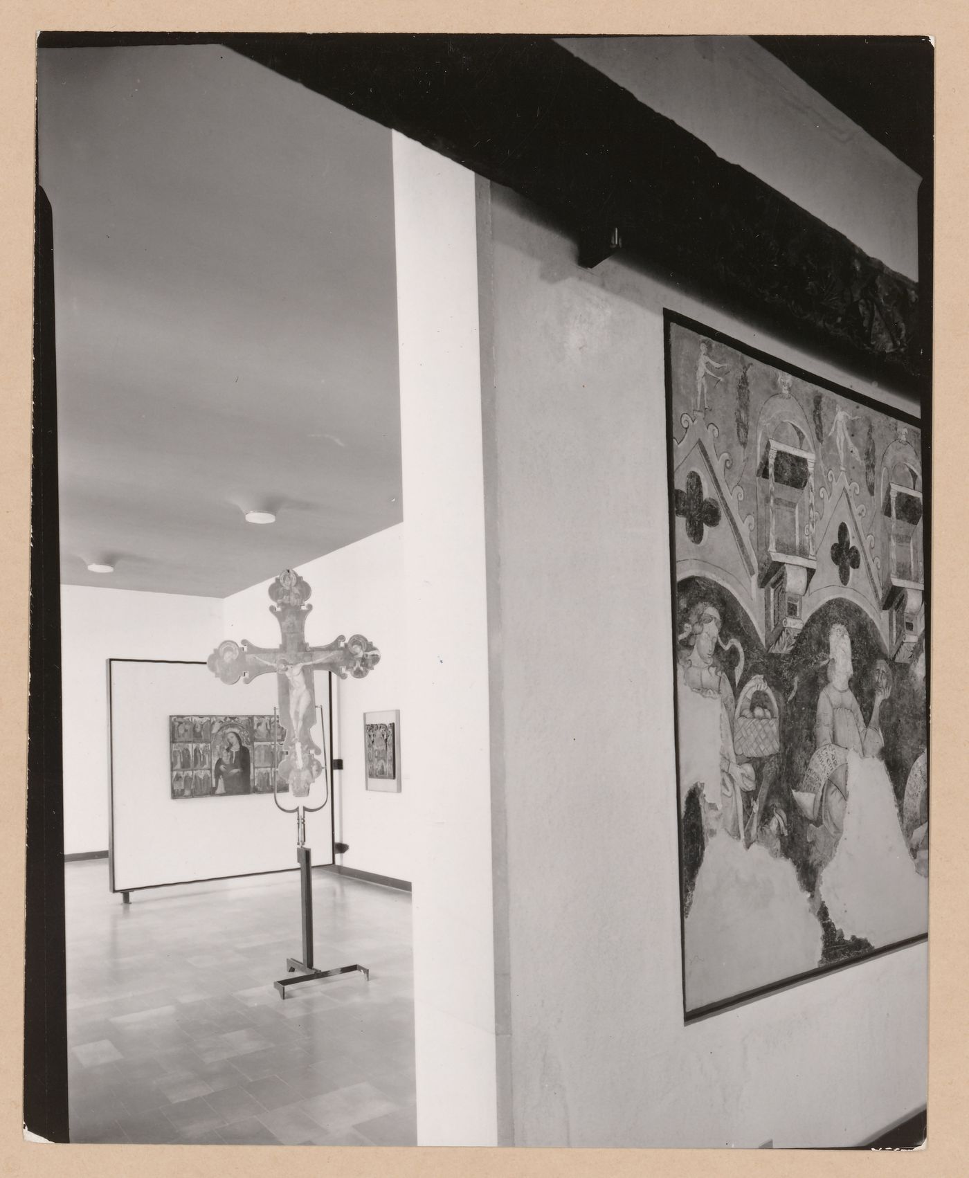Interior view of a galleries showing paintings and a freestanding painted crucifix, Museo Correr, Venice, Italy