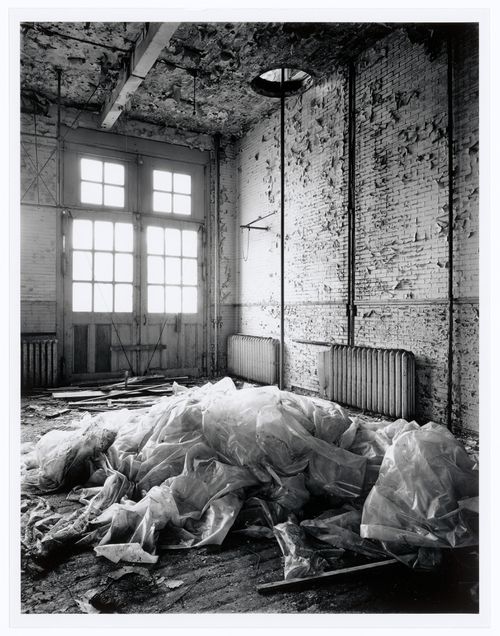 Interior view of the main floor of Fire Station no. 21 showing the sliding pole along the east wall, 1200 Mill Street, Montréal, Québec