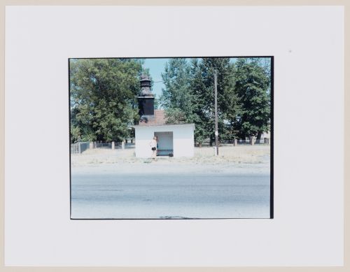 View of a bus shelter, a church tower, a road and people, Strzelce Kraje'nskie, Poland (from the series "In between cities")