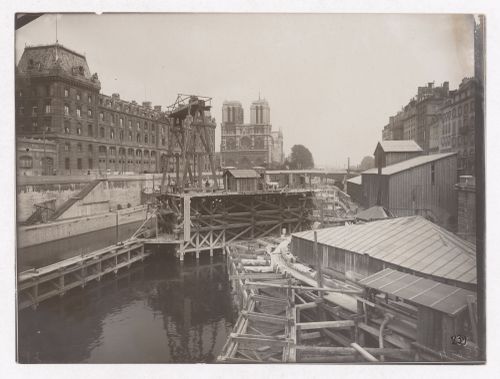 Construction of the Paris Metro, exterior view with the Seine and Notre Dame Cathedral in the background, Paris France