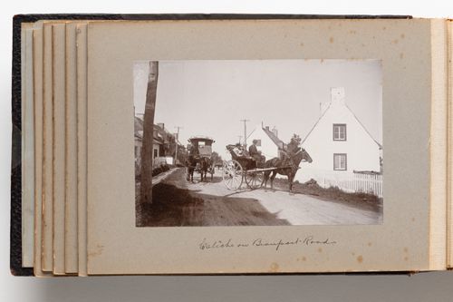 View of a horse-drawn carriage, with passengers and driver, on a road in Beauport (now Quebec City), Quebec, Canada