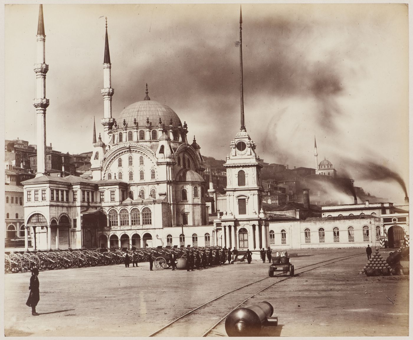 View of the Nusretiye Camii [Victory Mosque] (also known as the Tophane Mosque) with soldiers, artillery and rails in the foreground and a military building in the right background, Constantinople (now Istanbul), Ottoman Empire (now in Turkey)