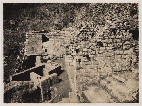 View of an unidentified building, the principal liturgical bath, the Serpent Gate located in the wall of the Torreón, and, at centre right, the entrance to the Royal Mausoleum, Machu Picchu, Peru