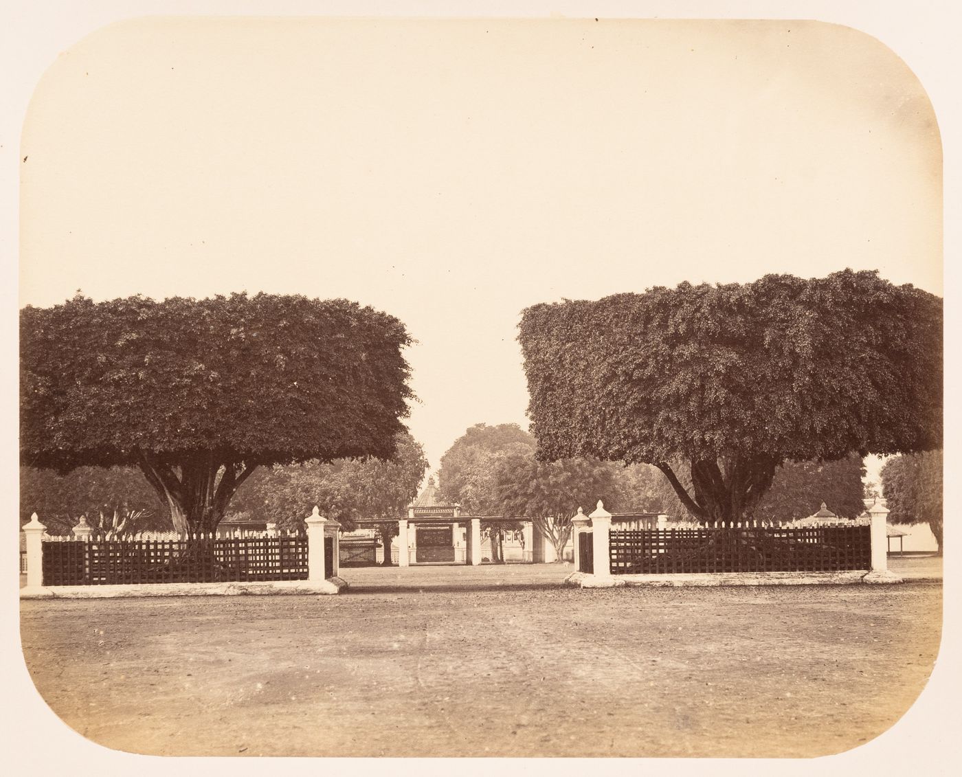 View of the entrance of the kraton [palace] of the Sultan of Yogyakarta showing fences and topiary, Dutch East Indies (now Indonesia)