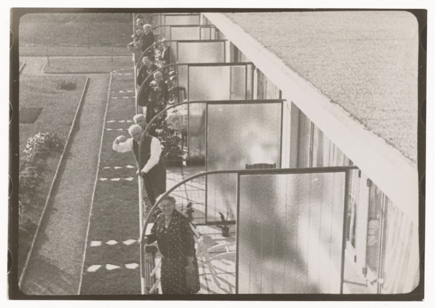 Exterior view of Budge Foundation Old People's Home showing residents standing on the second-floor balconies, Frankfurt am Main, Germany