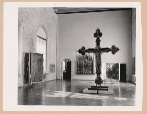 Interior view of a gallery showing a freestanding painted crucifix and paintings, Palazzo Abatellis, Galleria regionale della Sicilia, Palermo, Italy